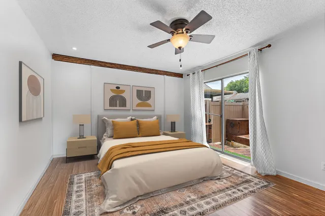 a bedroom with a large bed and a chandelier