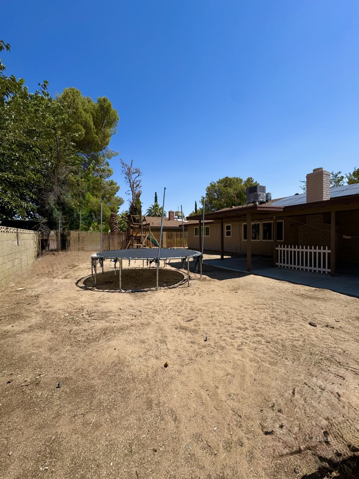 905 North Sierra View Street Ridgecrest, CA 93555 - Photo 30 of 30 a backyard of a house with table and chairs