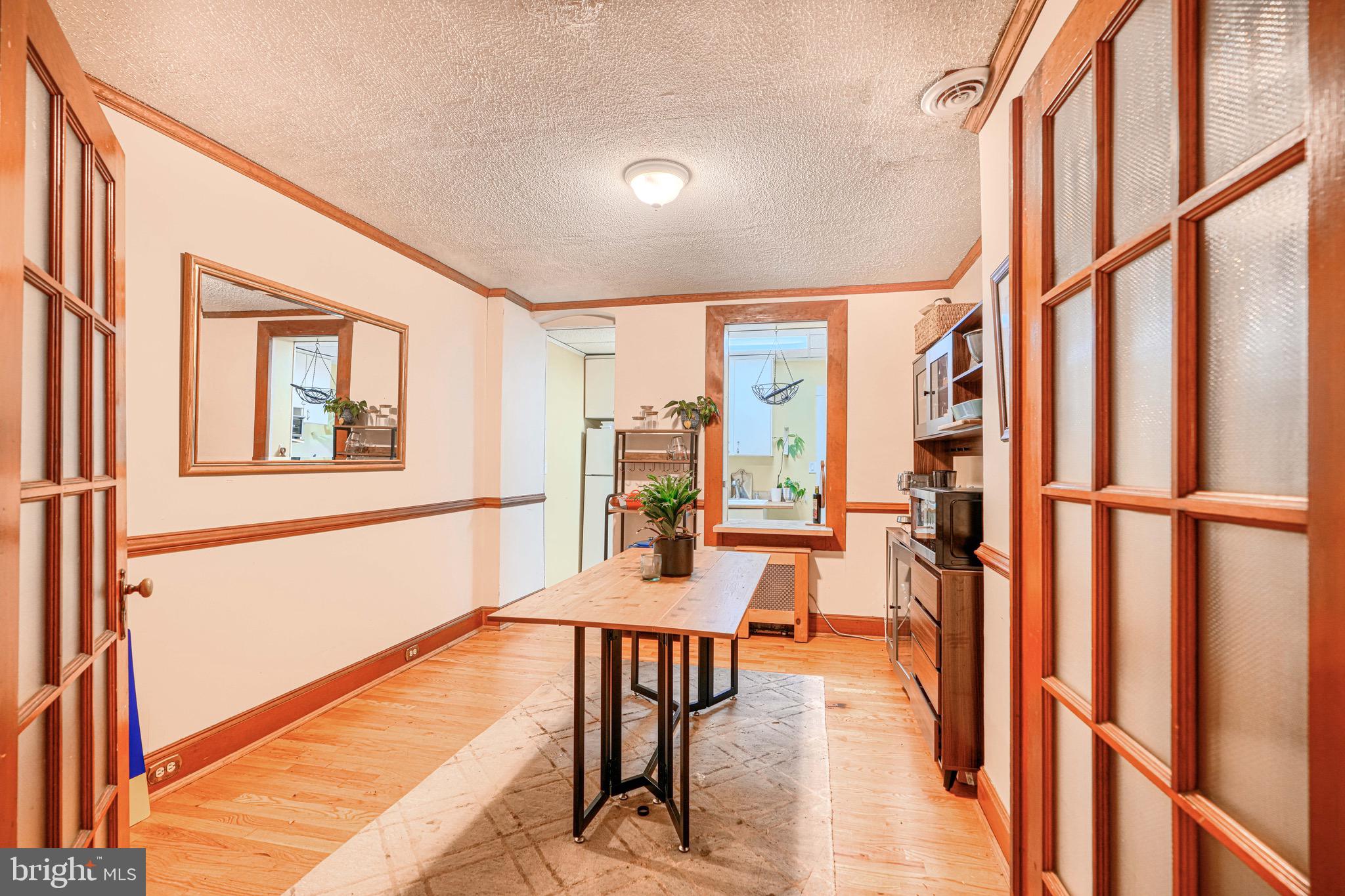 512 South Curley Street Baltimore, MD 21224 - Photo 11 of 29 a dining room with furniture and a floor to ceiling window