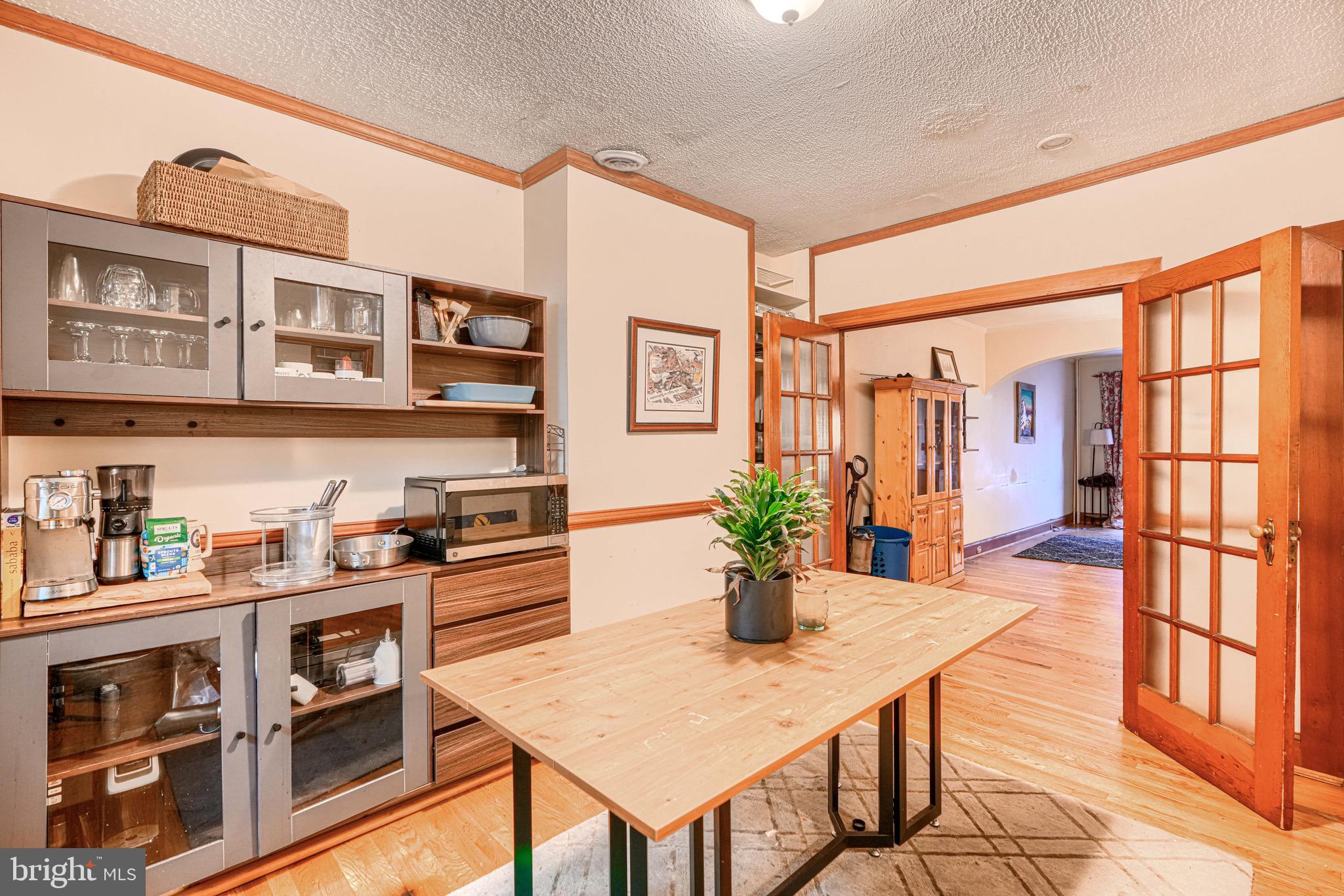 512 South Curley Street Baltimore, MD 21224 - Photo 13 of 29 a open kitchen with stainless steel appliances granite countertop a refrigerator a stove and a dining table with wooden floor