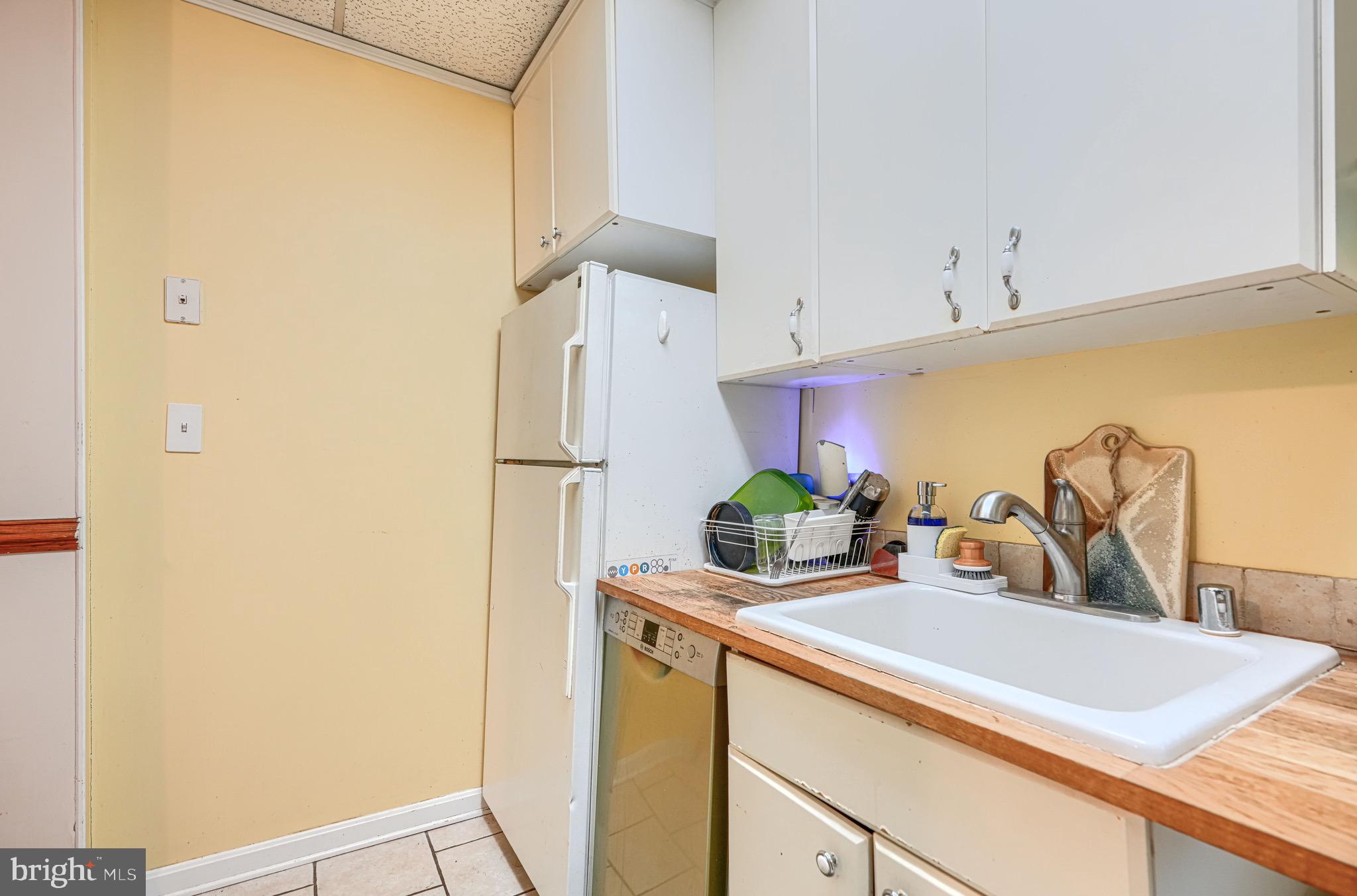 512 South Curley Street Baltimore, MD 21224 - Photo 16 of 29 a kitchen with stainless steel appliances a sink and a refrigerator