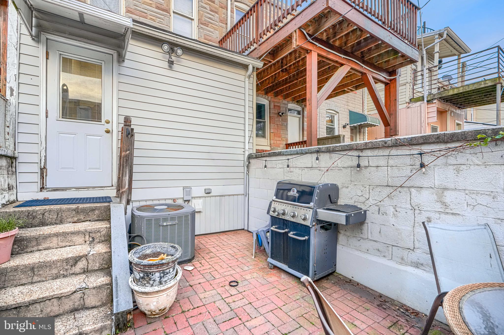 512 South Curley Street Baltimore, MD 21224 - Photo 17 of 29 a view of a patio with table and chairs and barbeque