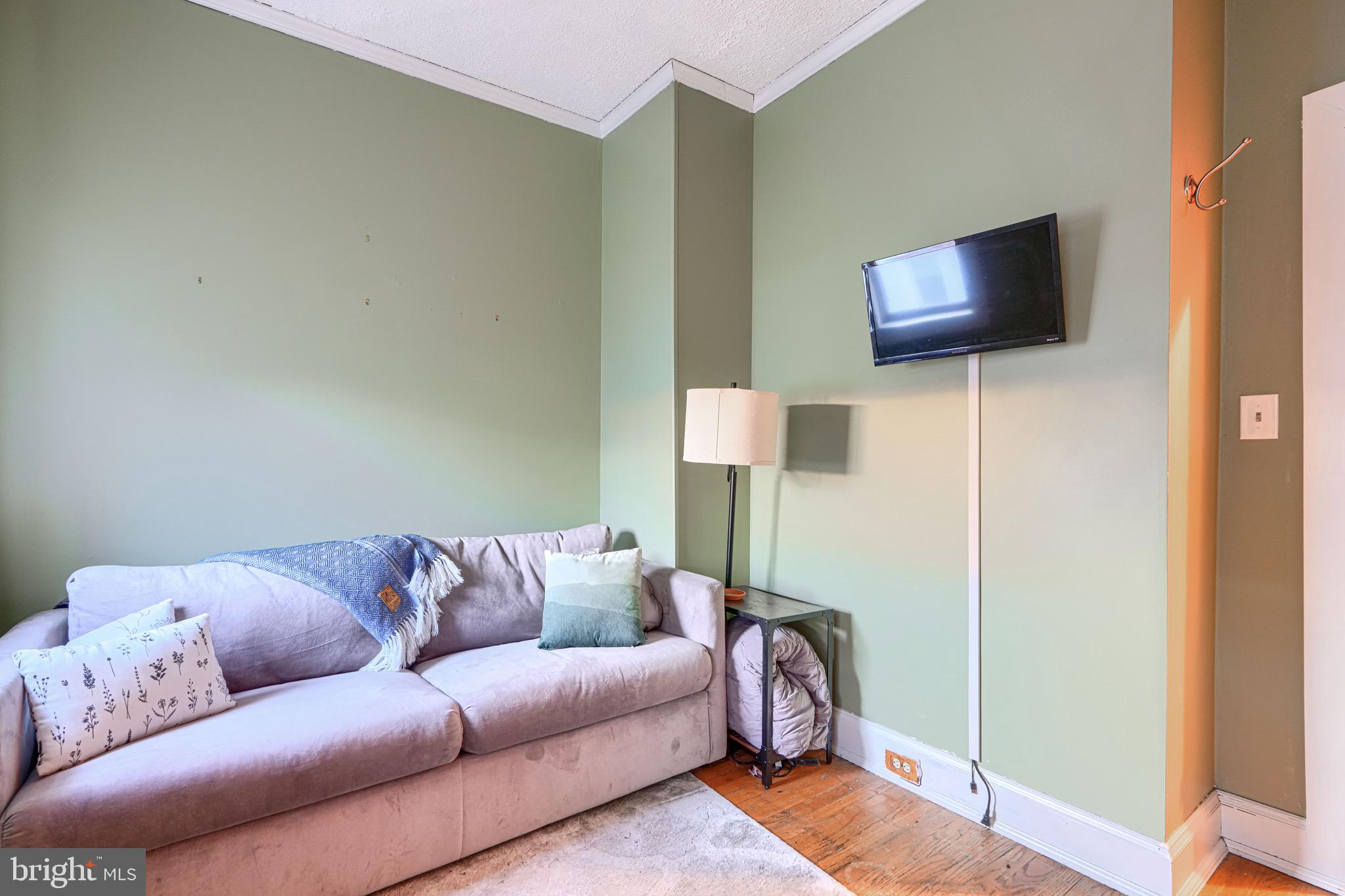 512 South Curley Street Baltimore, MD 21224 - Photo 21 of 29 a living room with furniture and a flat screen tv