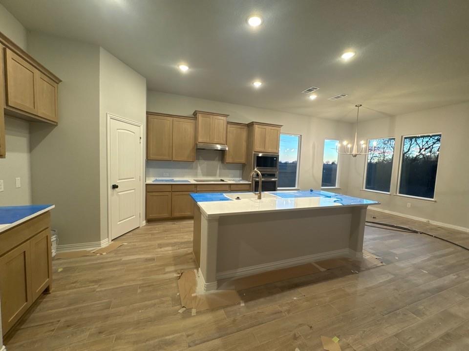 9007 County Road 623 Blue Ridge, TX 75424 - Photo 6 of 13 a large kitchen with kitchen island a sink stainless steel appliances and cabinets