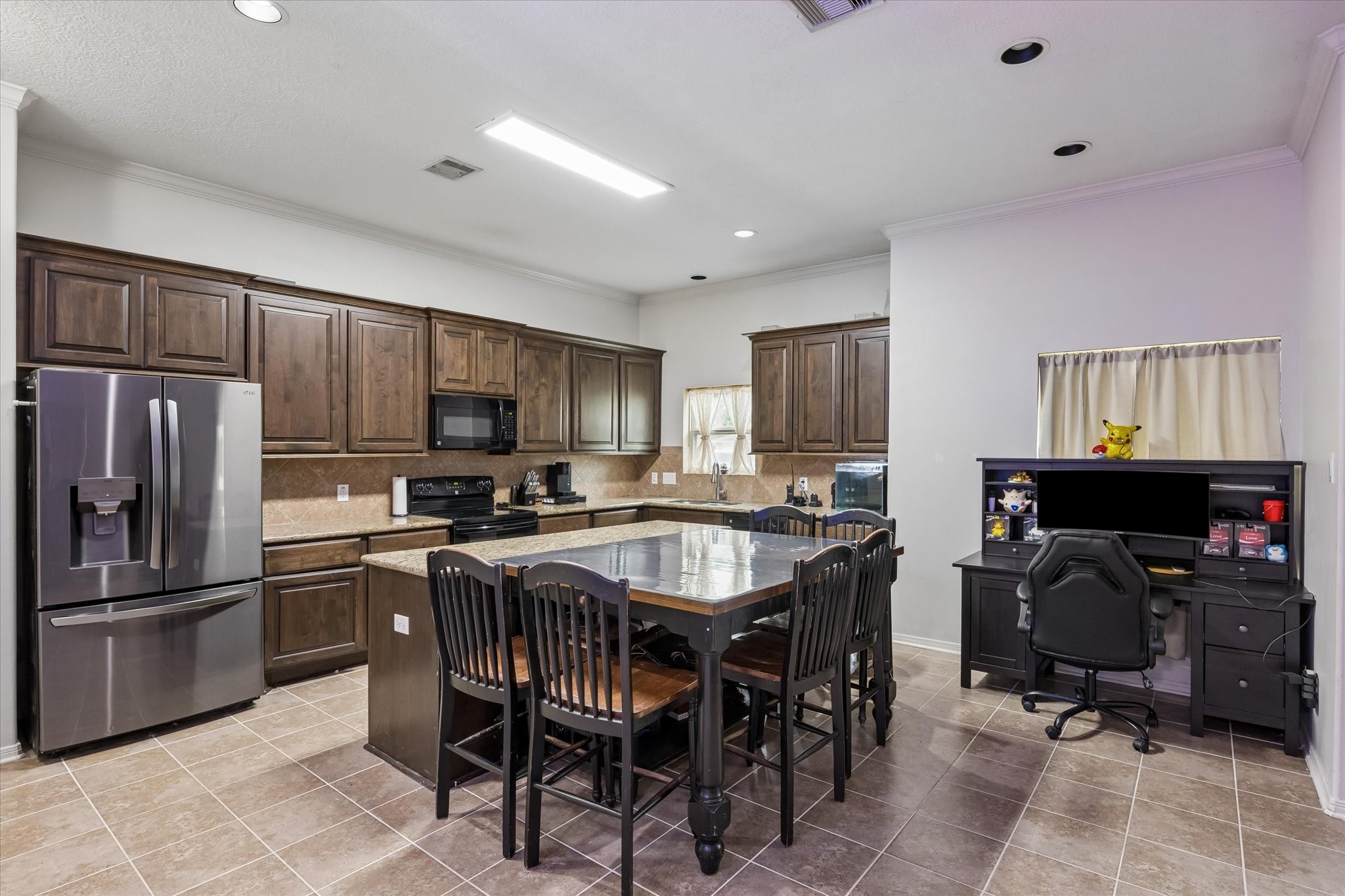 1741 Eagle Lake Road Sealy, TX 77474 - Photo 5 of 15 a kitchen with granite countertop stainless steel appliances a sink dishwasher a refrigerator cabinets and furniture