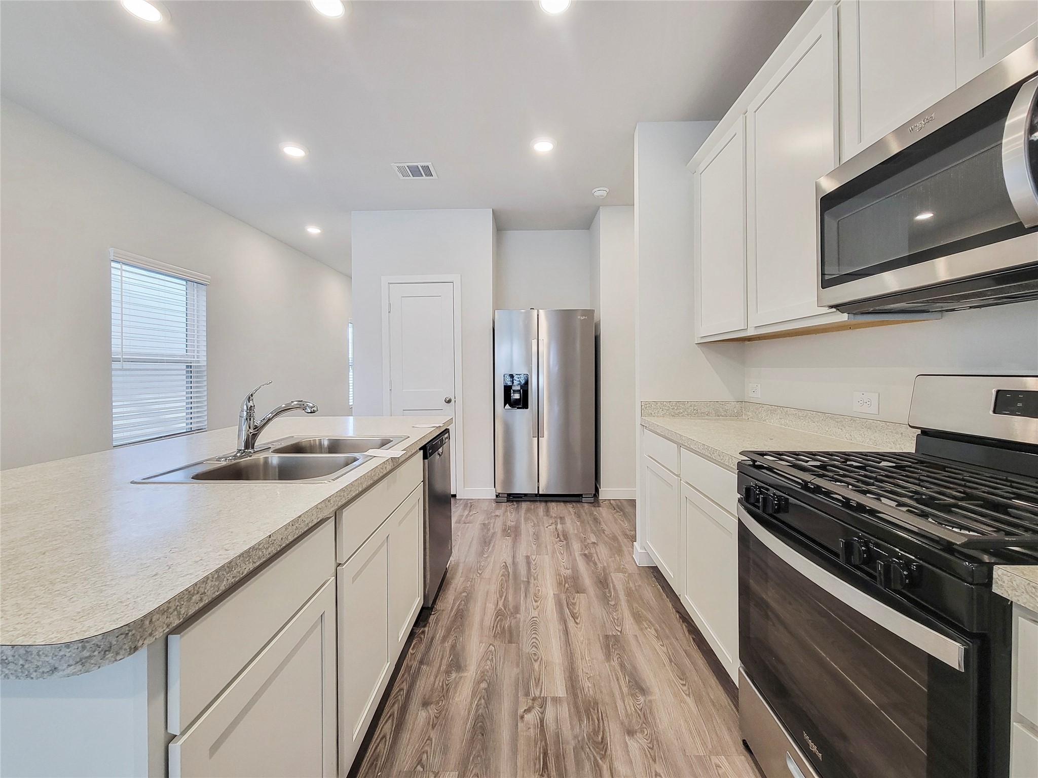 16954 Pandora Way Porter, TX 77365 - Photo 5 of 18 a kitchen with stainless steel appliances granite countertop a sink stove and refrigerator