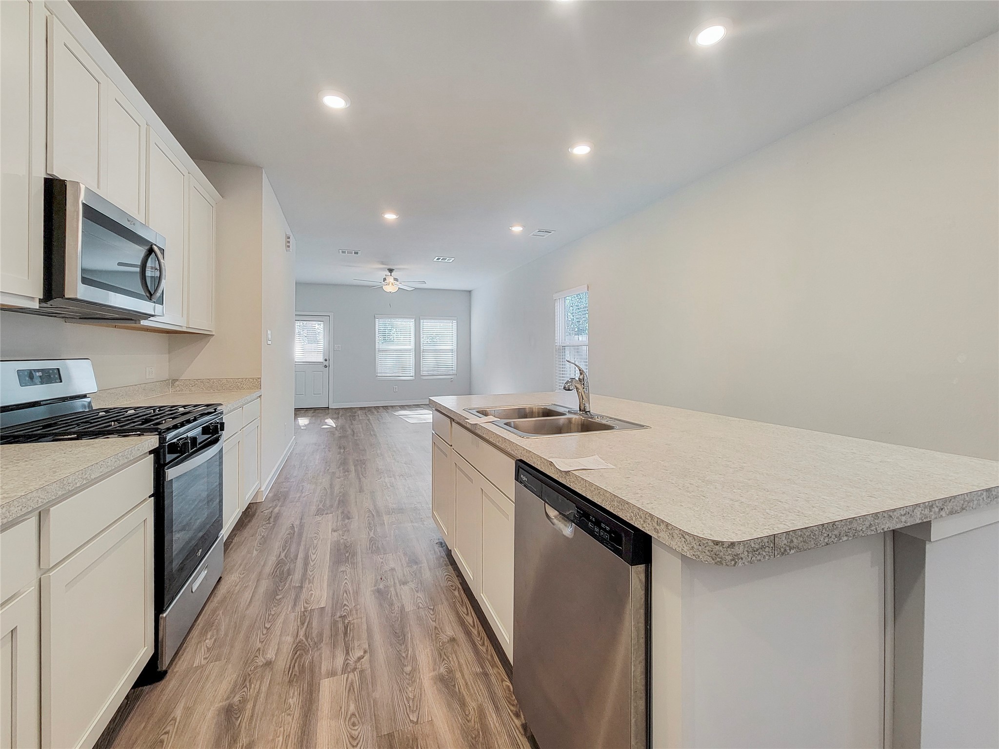 16954 Pandora Way Porter, TX 77365 - Photo 6 of 18 a large kitchen with stainless steel appliances granite countertop a lot of counter space and wooden floor