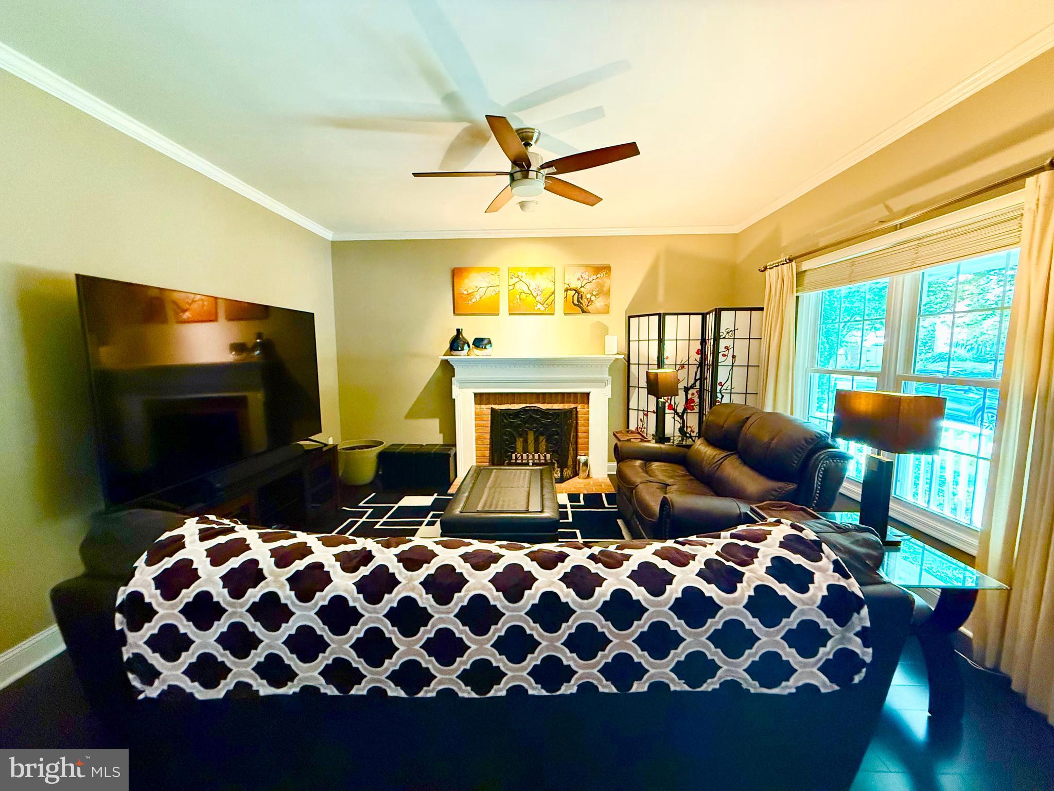 2462 Five Shillings Road Frederick, MD 21701 - Photo 14 of 55 a living room with furniture a fireplace and a flat screen tv