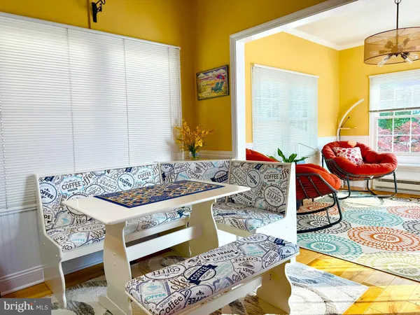 a living room with stainless steel appliances granite countertop furniture and a rug