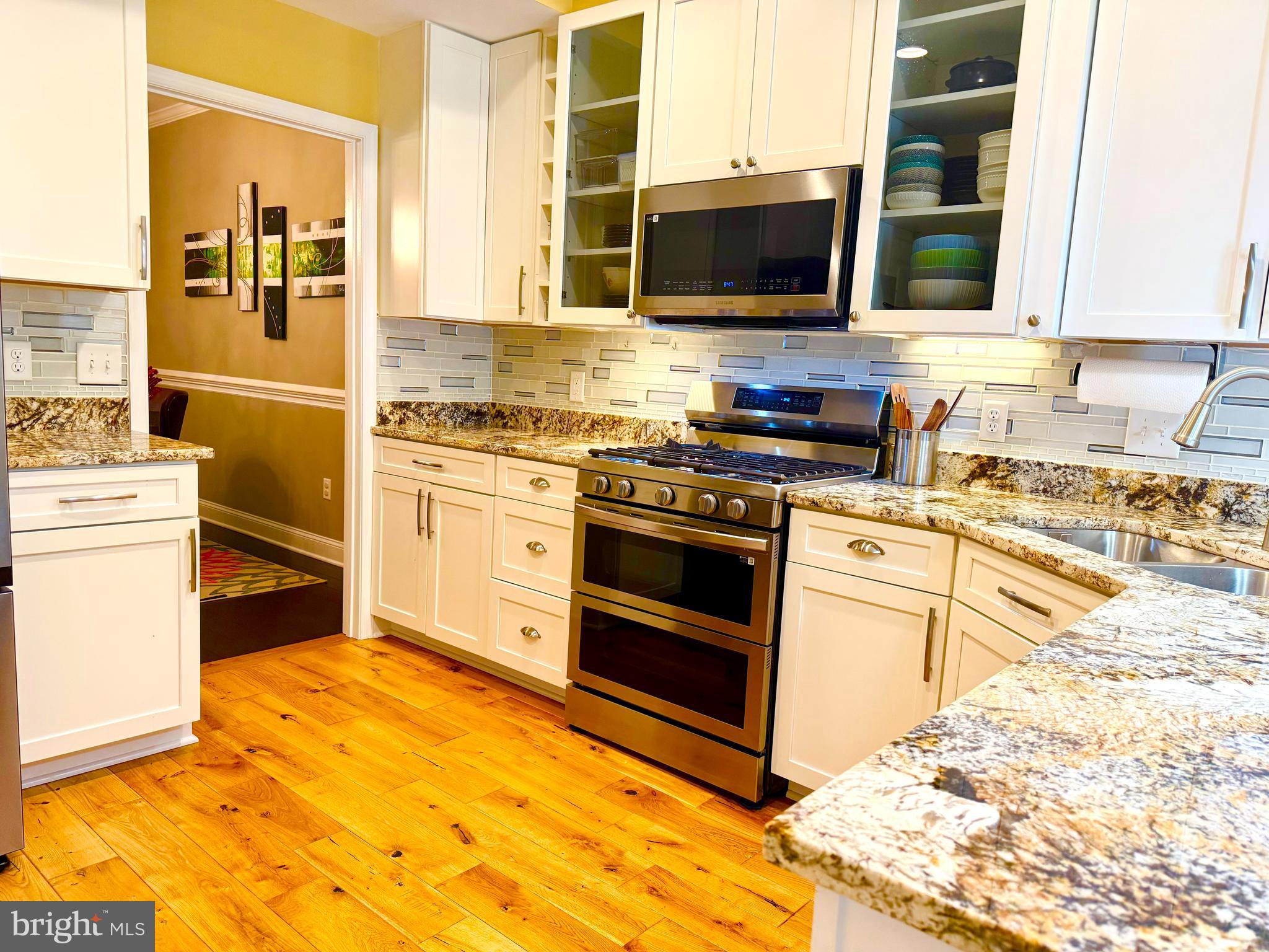 2462 Five Shillings Road Frederick, MD 21701 - Photo 6 of 55 a kitchen with stainless steel appliances a stove a sink and a microwave