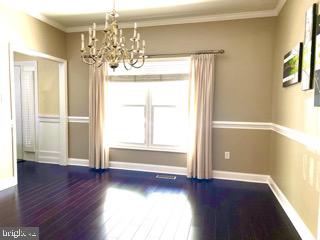 2462 Five Shillings Road Frederick, MD 21701 - Photo 10 of 55 a view of an empty room with wooden floor and a window