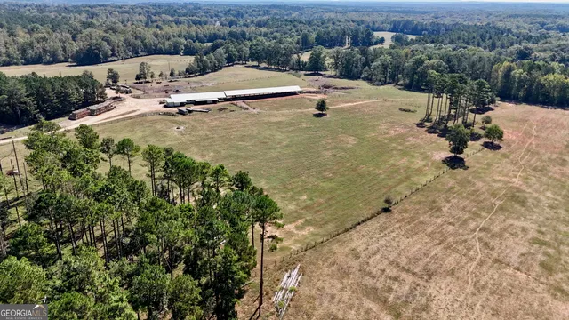 an aerial view of a house with a yard