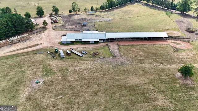 an aerial view of a house with a yard and ocean view