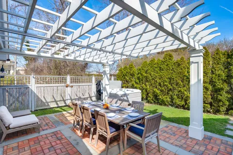 a view of a patio with a table chairs and a backyard