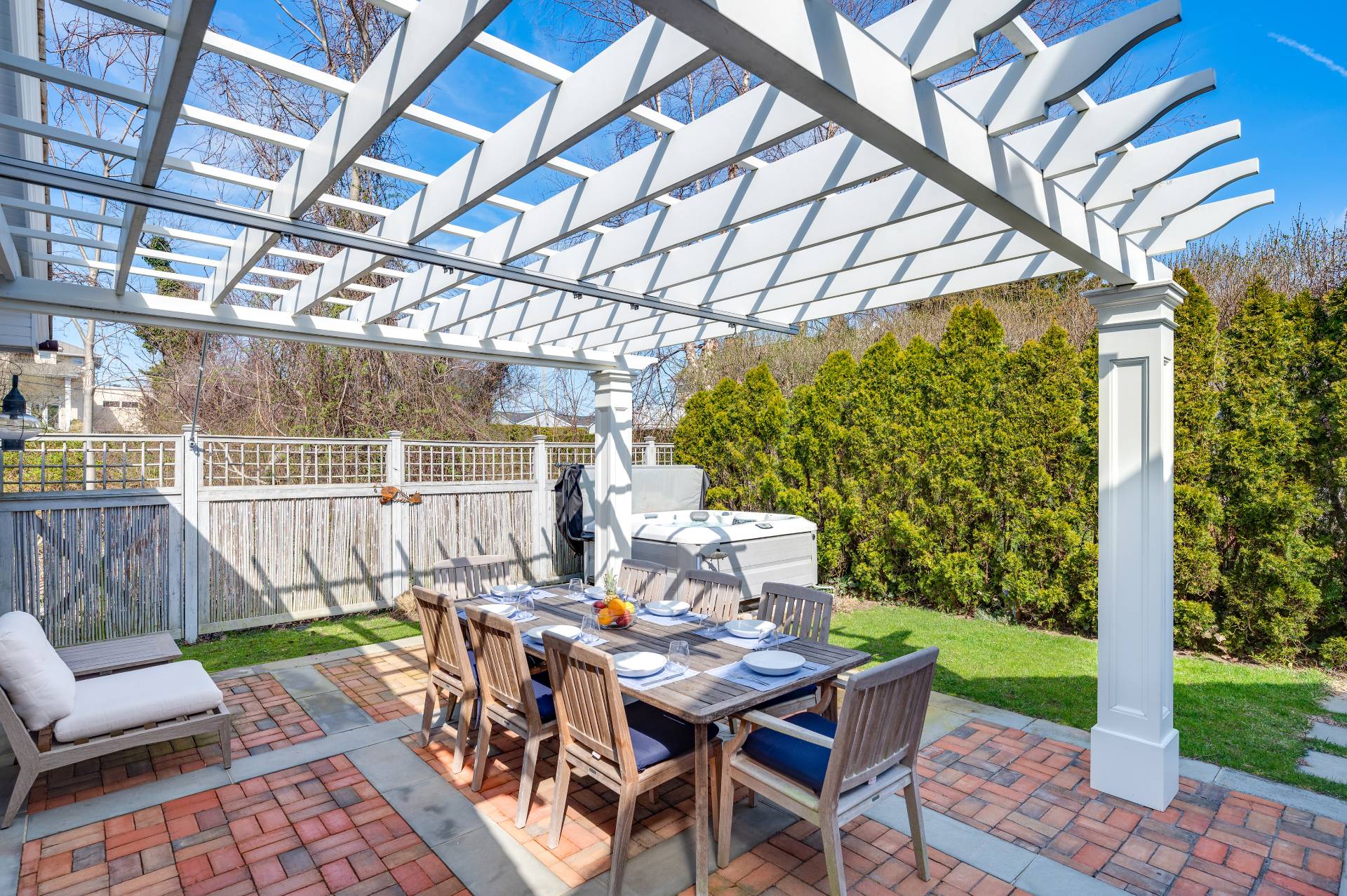 5 Ridge Drive Sag Harbor, NY 11963 - Photo 18 of 27 a view of a patio with a table chairs and a backyard