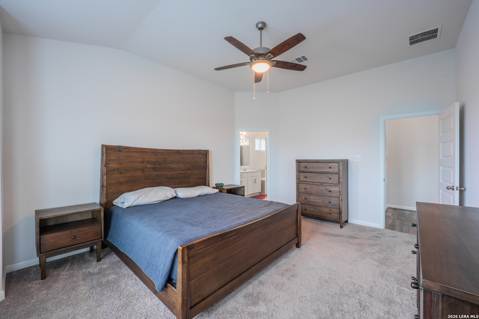 4947 Ranahan Pass St. Hedwig, TX 78152 - Photo 16 of 37 a bedroom with a bed and a chandelier