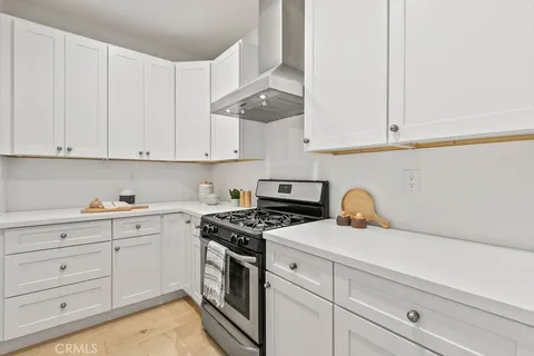 a large kitchen with a large window and stainless steel appliances
