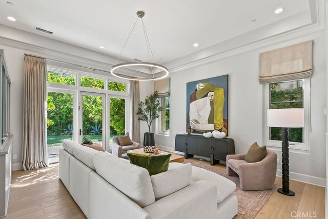 a living room with fireplace furniture and a large window