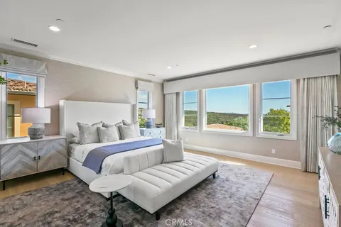 a bedroom with a large bed and a couch