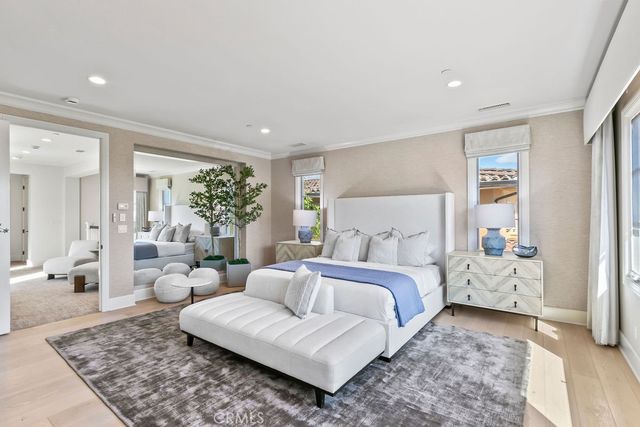 a large living room with white couches chair and fireplace
