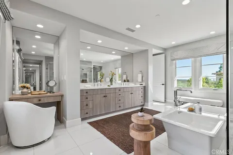 a bathroom with a tub sink and mirror