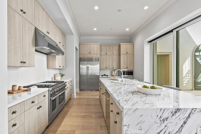 a view of a kitchen with furniture and large windows