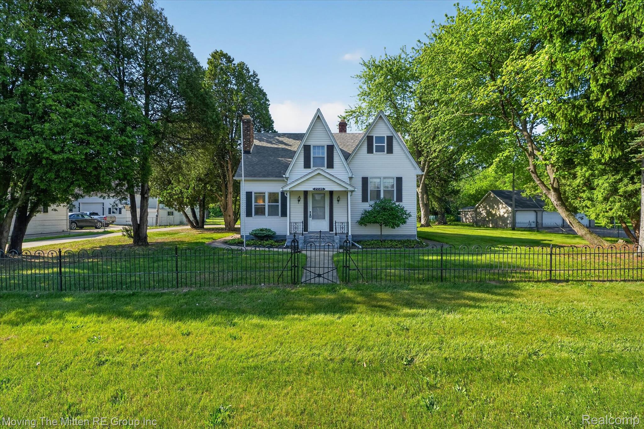 25505 Wick Road Taylor, MI 48180 - Photo 3 of 68 View of front of house with a chimney, a fenced front yard, and a gate
