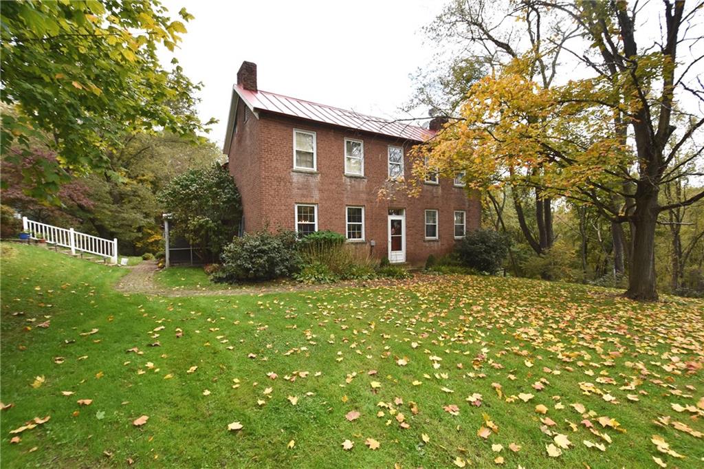465 Bavington Road Burgettstown, PA 15021 - Photo 1 of 25 a brick house with a large tree in front of it