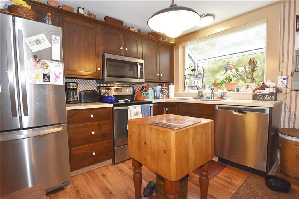 465 Bavington Road Burgettstown, PA 15021 - Photo 5 of 25 a kitchen with a refrigerator a microwave a sink and a stove