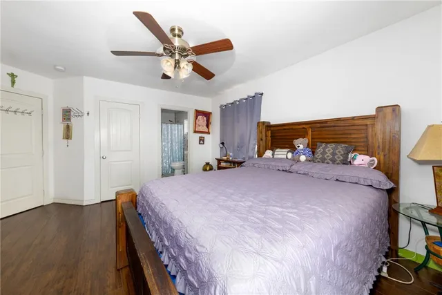a bed room with a bed and a ceiling fan