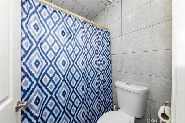 a white toilet sitting next to a bathroom sink
