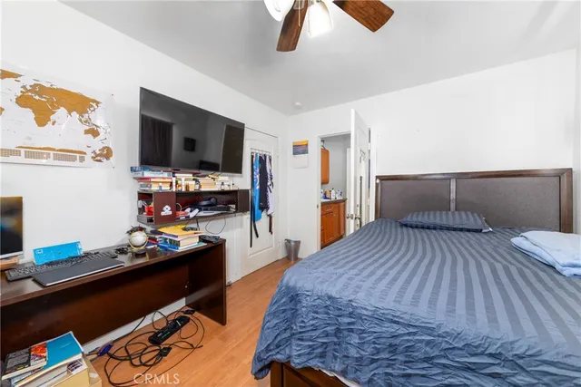 a bed room with a bed and a television