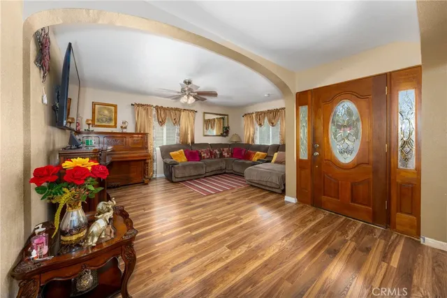 a living room with furniture a chandelier and a fireplace
