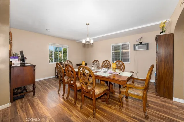 a view of a dining room with furniture and wooden floor