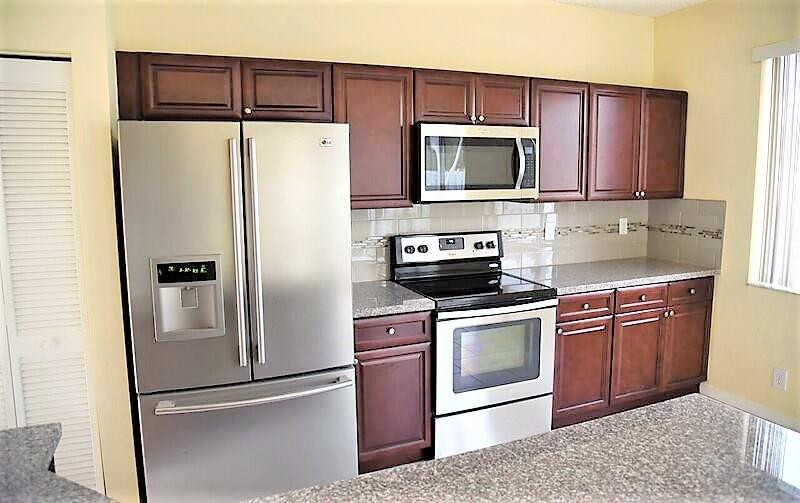 552 Talavera Road Weston, FL 33326 - Photo 1 of 16 a kitchen with stainless steel appliances granite countertop a refrigerator stove a sink and dishwasher
