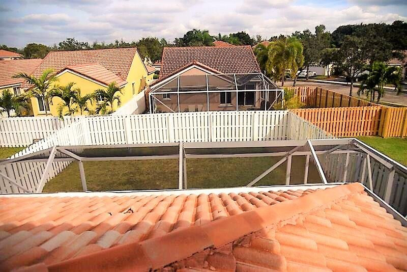 552 Talavera Road Weston, FL 33326 - Photo 15 of 16 a view of a house with a wooden deck