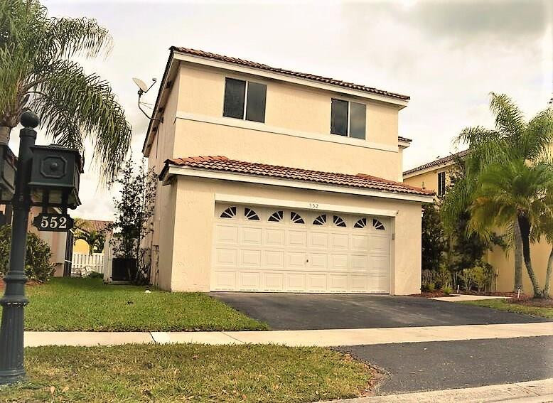 552 Talavera Road Weston, FL 33326 - Photo 2 of 16 a white house with a outdoor space