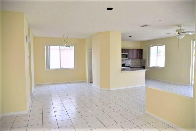 552 Talavera Road Weston, FL 33326 - Photo 5 of 16 a view of a kitchen with a sink and a refrigerator