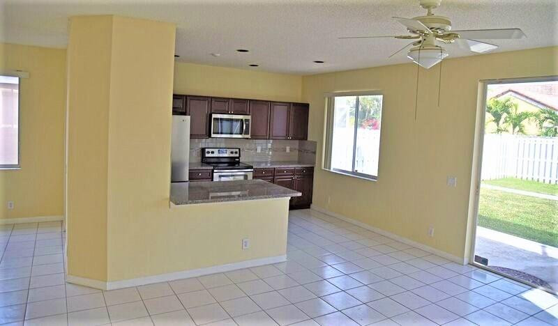552 Talavera Road Weston, FL 33326 - Photo 7 of 16 a view of kitchen with furniture and window