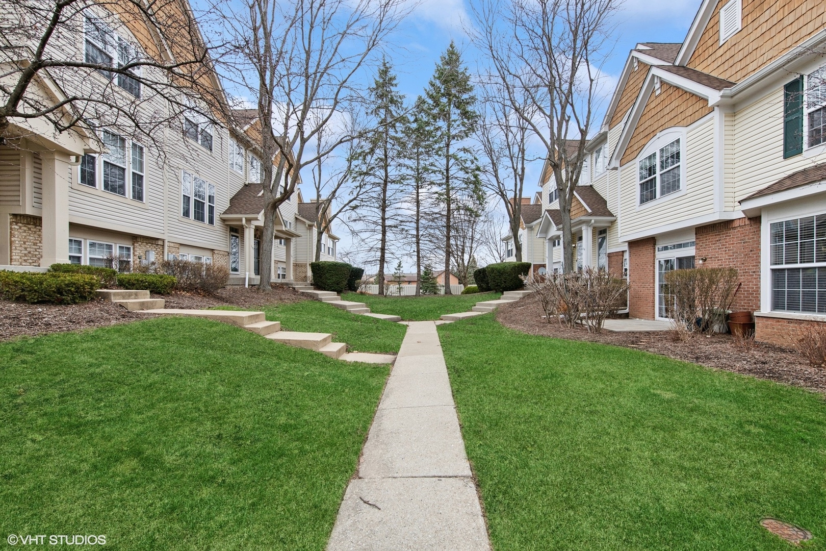 1136 Georgetown Way Vernon Hills, IL 60061 - Photo 2 of 21 a view of a yard with plants and large trees