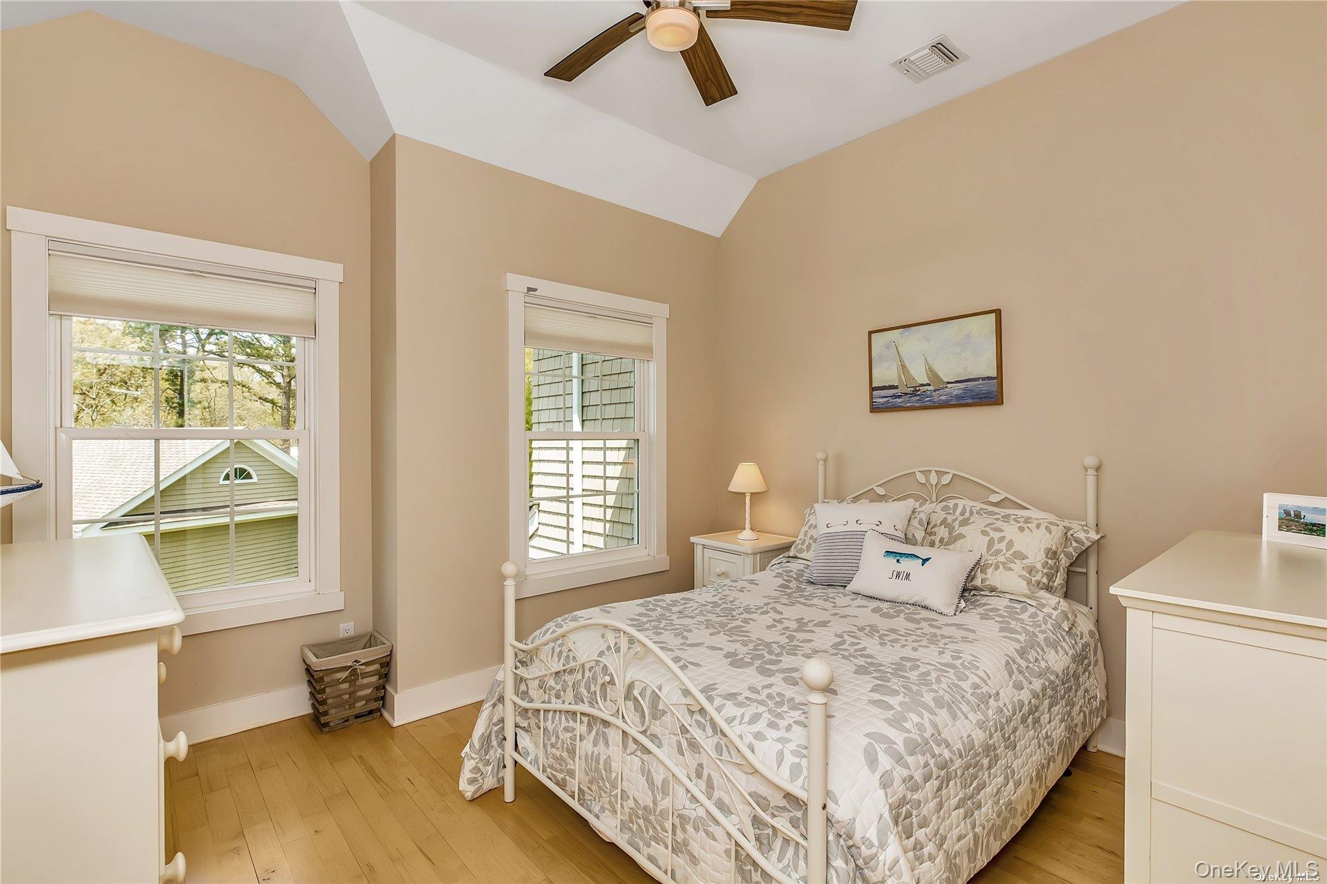 20 Canoe Place Road, Unit 8 Hampton Bays, NY 11946 - Photo 11 of 18 a bedroom with a bed and wooden floor