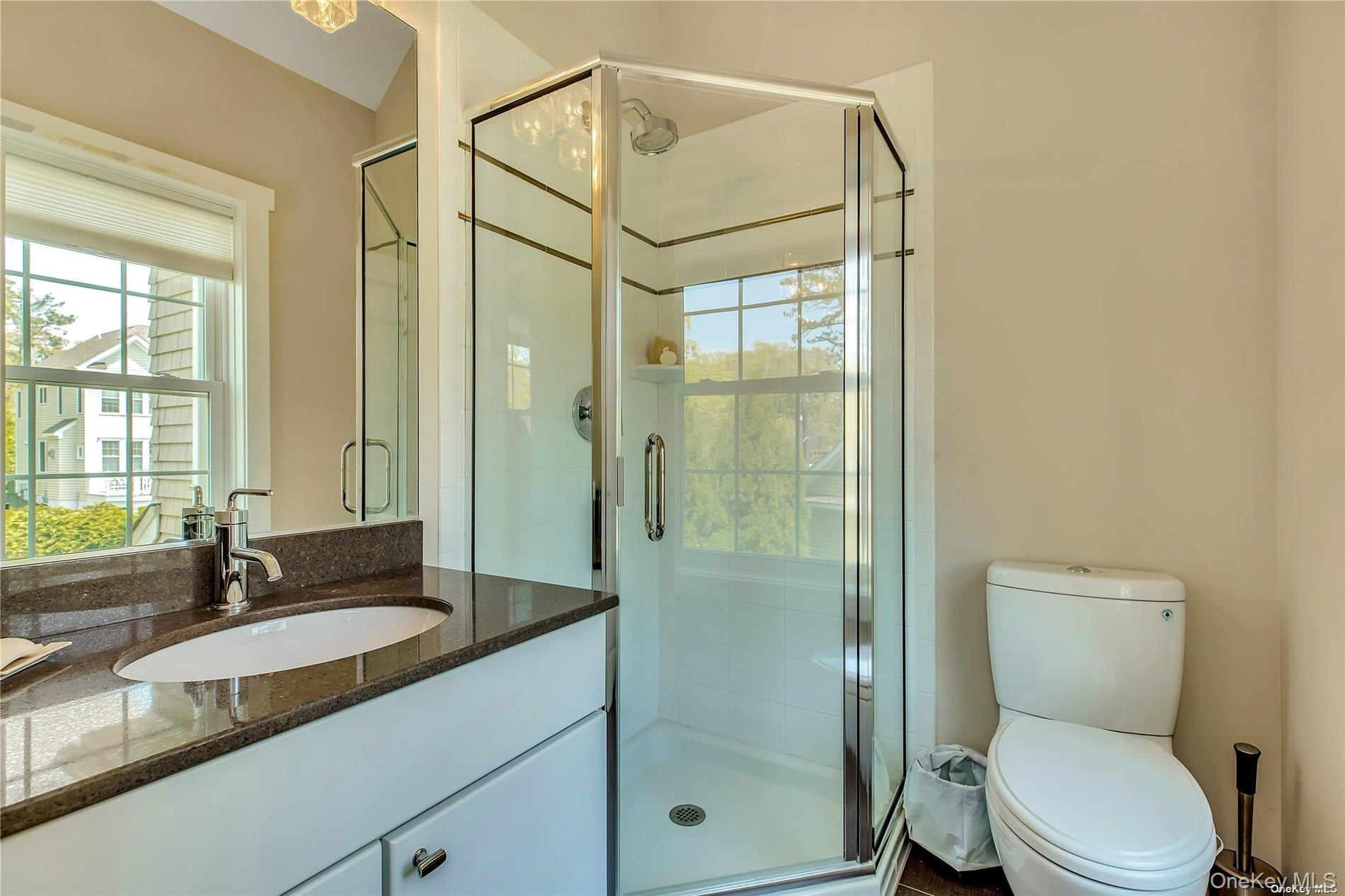 20 Canoe Place Road, Unit 8 Hampton Bays, NY 11946 - Photo 12 of 18 a bathroom with a sink a toilet and shower