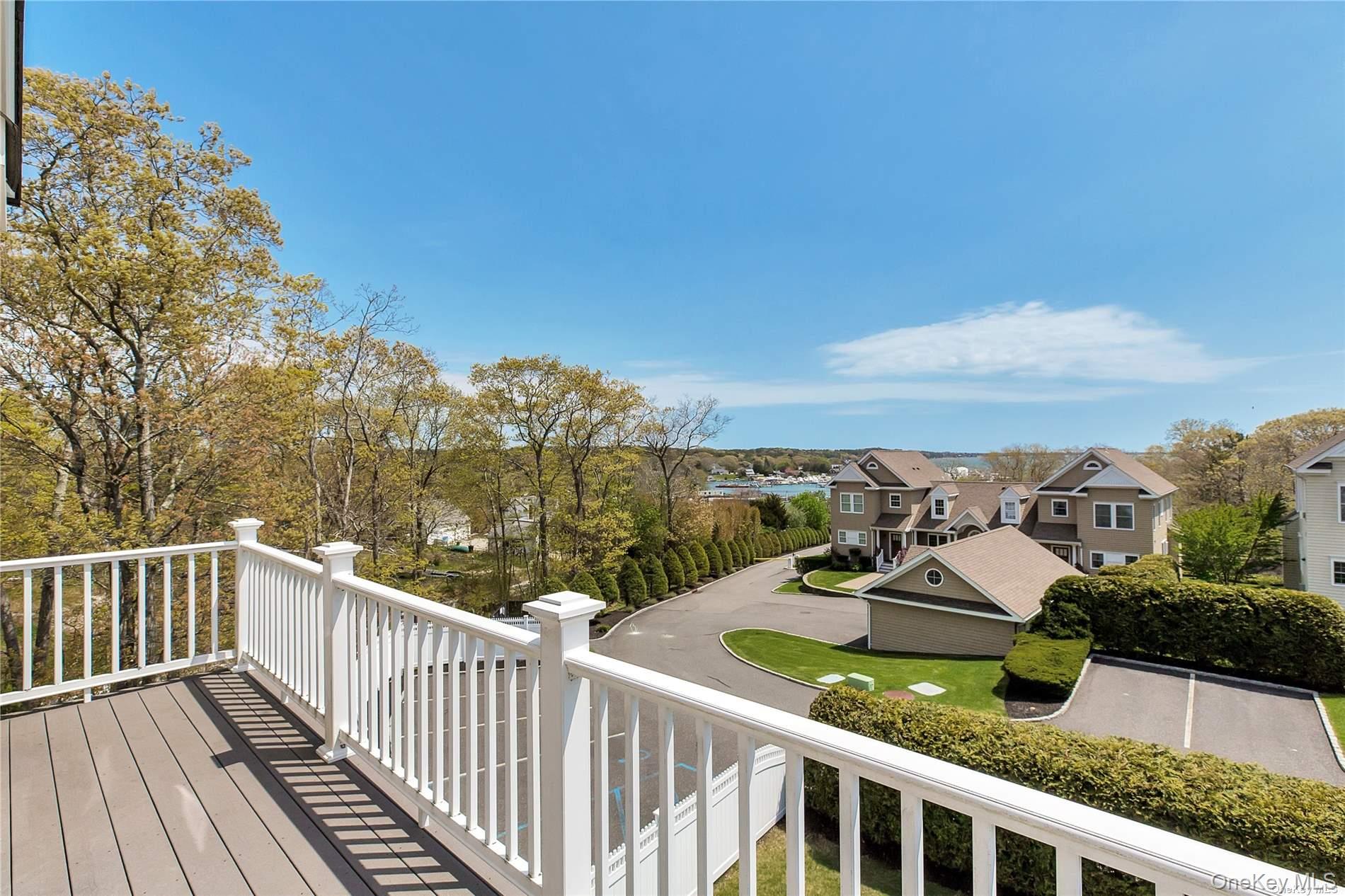 20 Canoe Place Road, Unit 8 Hampton Bays, NY 11946 - Photo 13 of 18 a view of a balcony with wooden chairs