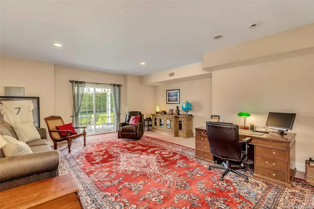 a view of a livingroom with workspace and a couch
