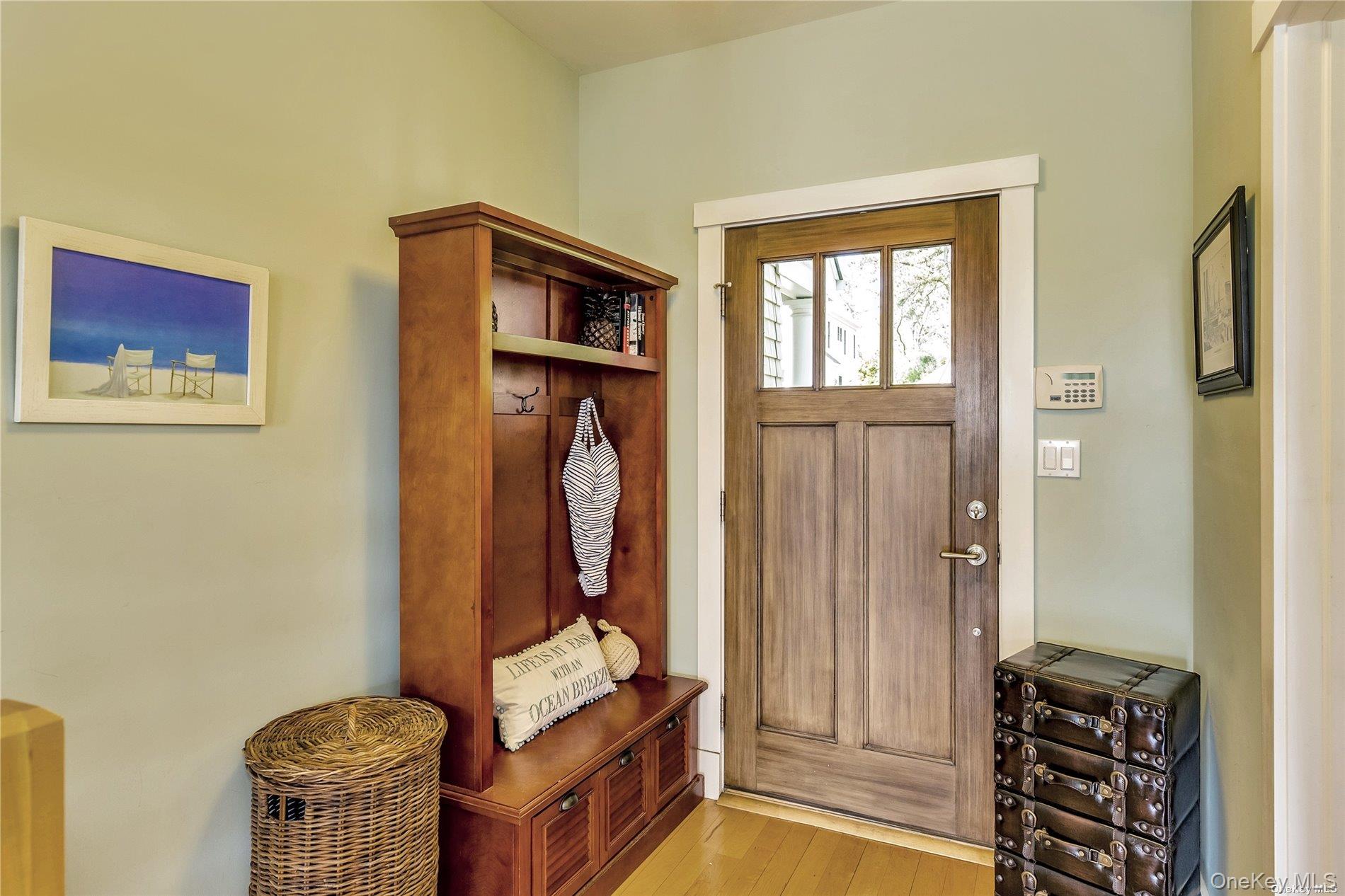 20 Canoe Place Road, Unit 8 Hampton Bays, NY 11946 - Photo 2 of 18 a front view of a house with entryway and wooden floor