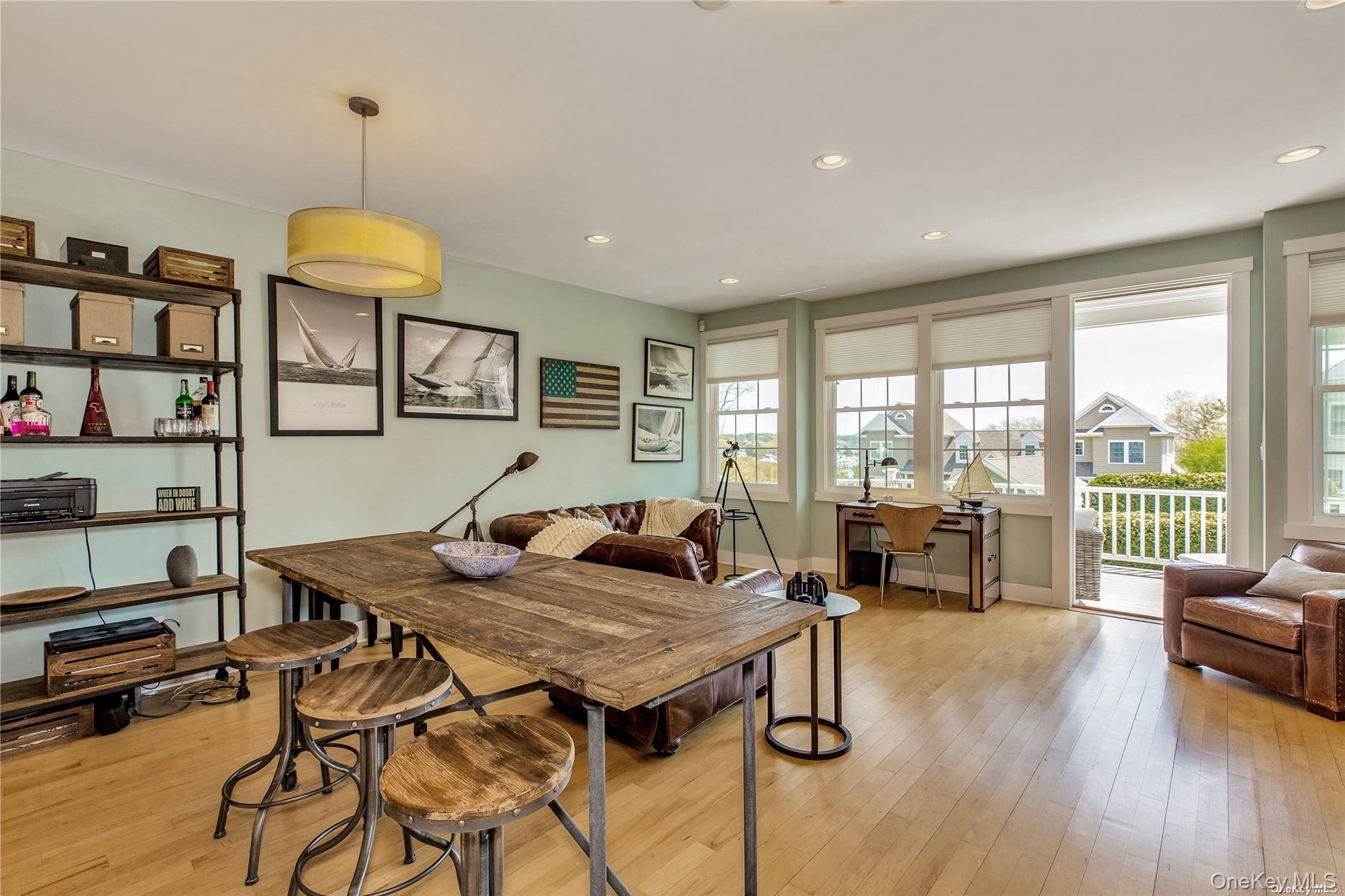 20 Canoe Place Road, Unit 8 Hampton Bays, NY 11946 - Photo 3 of 18 a living room with furniture and a large window