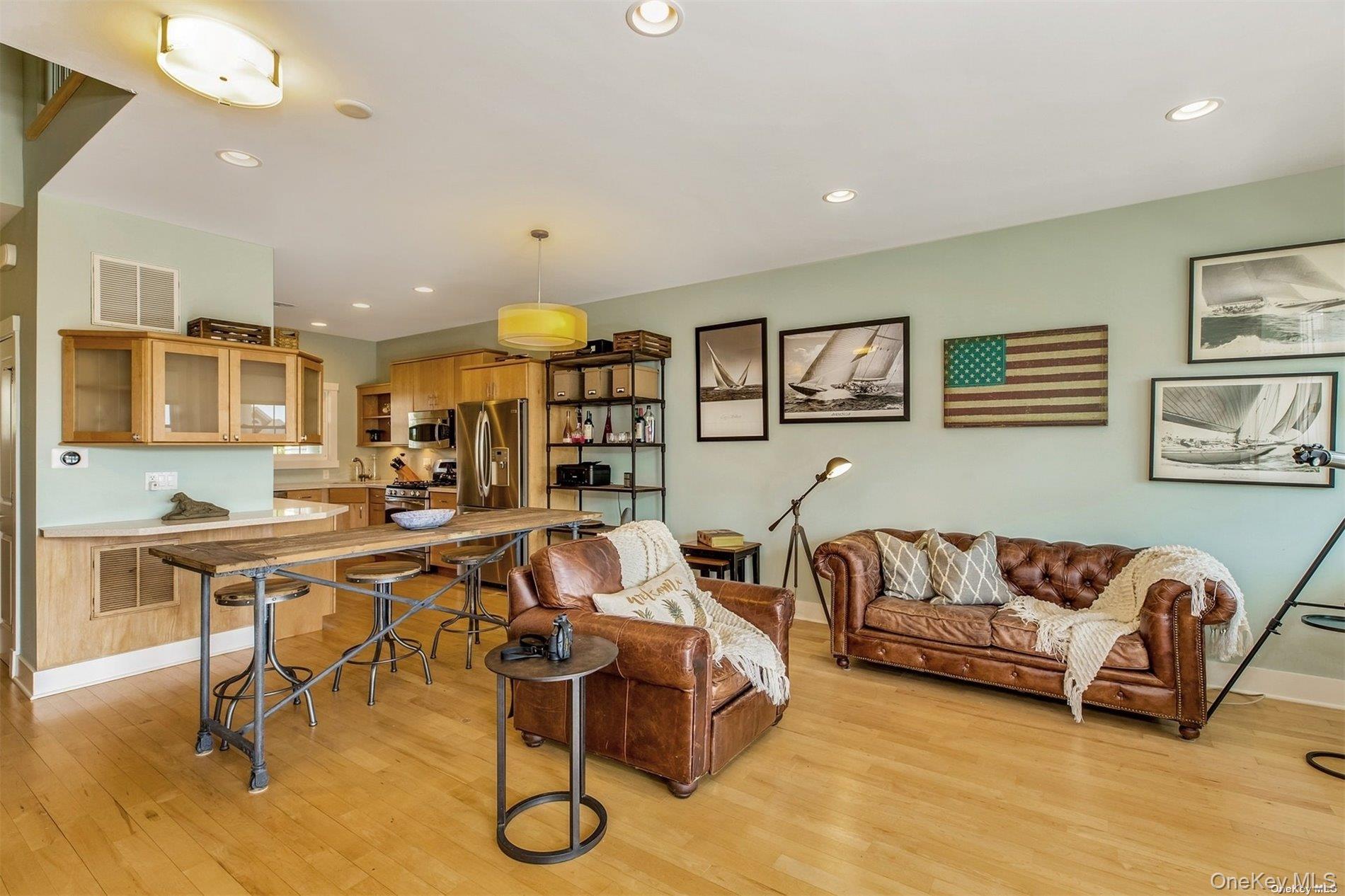 20 Canoe Place Road, Unit 8 Hampton Bays, NY 11946 - Photo 5 of 18 a living room with furniture kitchen view and a wooden floor