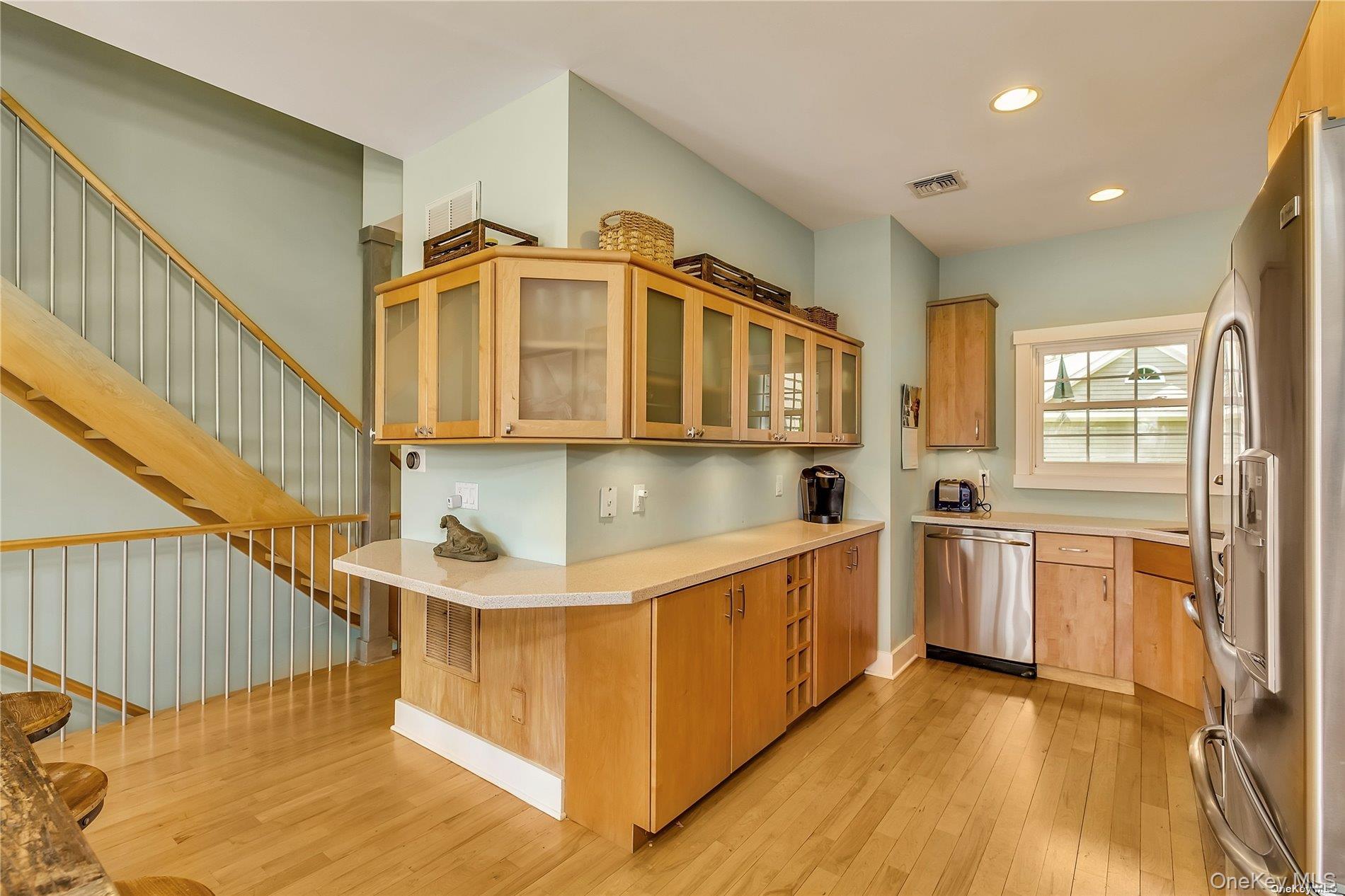 20 Canoe Place Road, Unit 8 Hampton Bays, NY 11946 - Photo 7 of 18 a kitchen with stainless steel appliances granite countertop a sink and a stove top oven