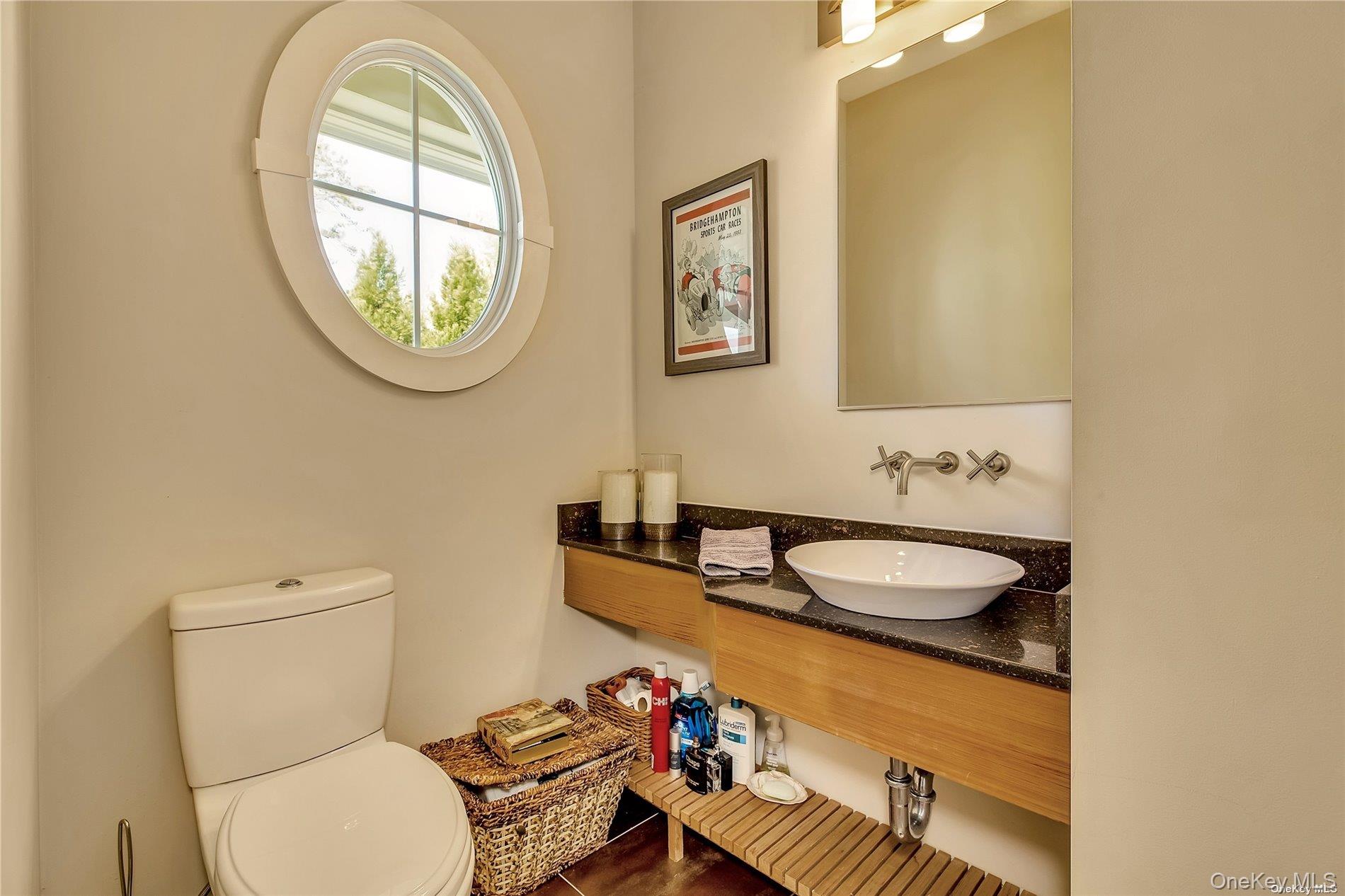 20 Canoe Place Road, Unit 8 Hampton Bays, NY 11946 - Photo 8 of 18 a bathroom with a sink and a mirror