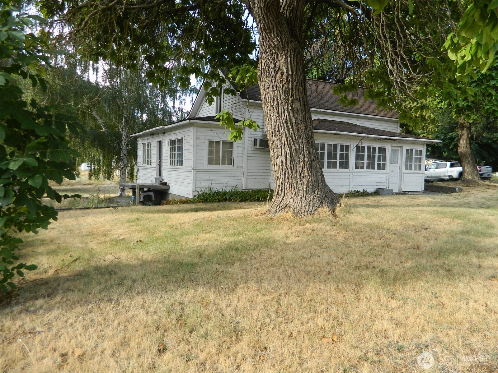 26 Palmer Avenue Loomis, WA 98827 - Photo 2 of 20 a front view of a house with a yard and large trees